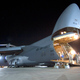 With the nose of the aircraft raised above the flight deck and rear clamshell doors open, airmen of the US Air Force unload a Lockheed C-5 Galaxy at the Balad Air Base in Iraq in 2008 (US Air Force)